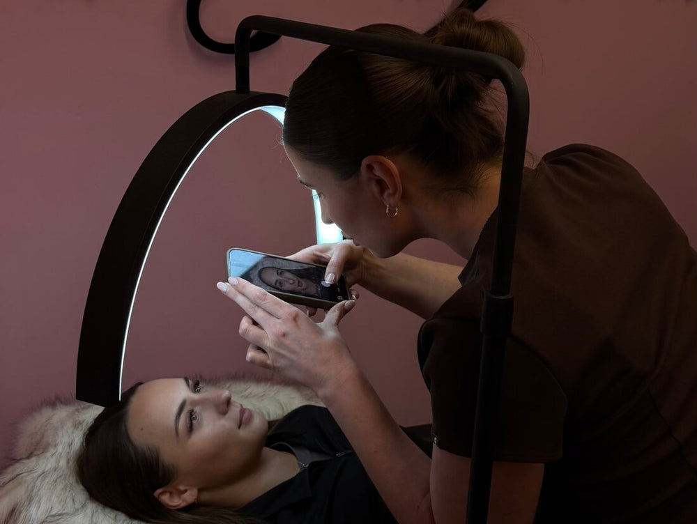 A student taking photos of her finished lash set